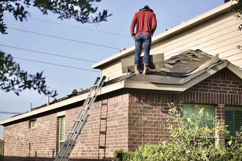 Professional roofer working on a residential roof in Hemet